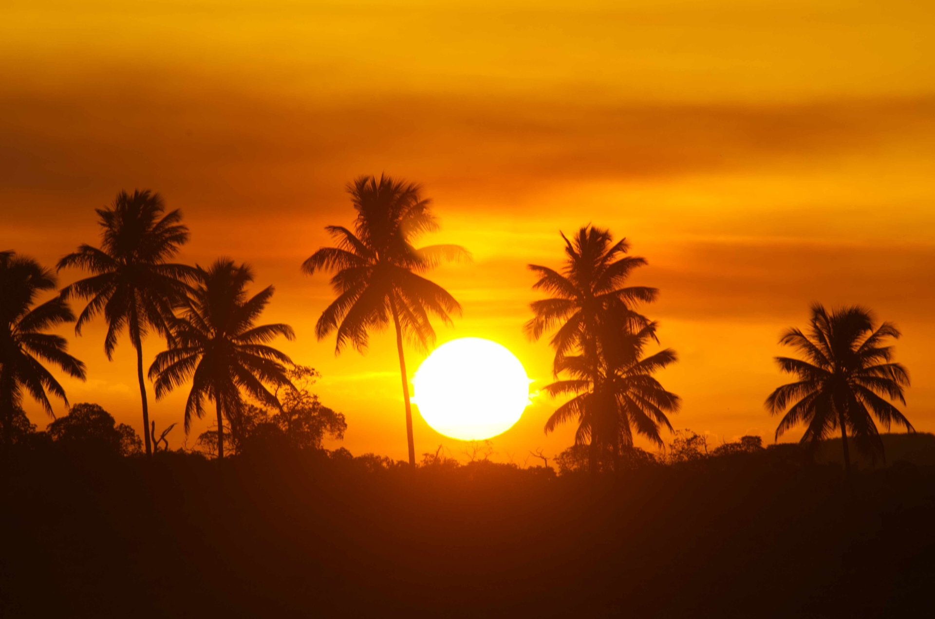 Warm tropical sunset over distant headlands